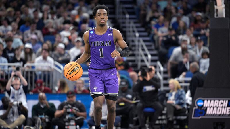 Furman guard JP Pegues (1) brings the ball up the court during the second half of a...