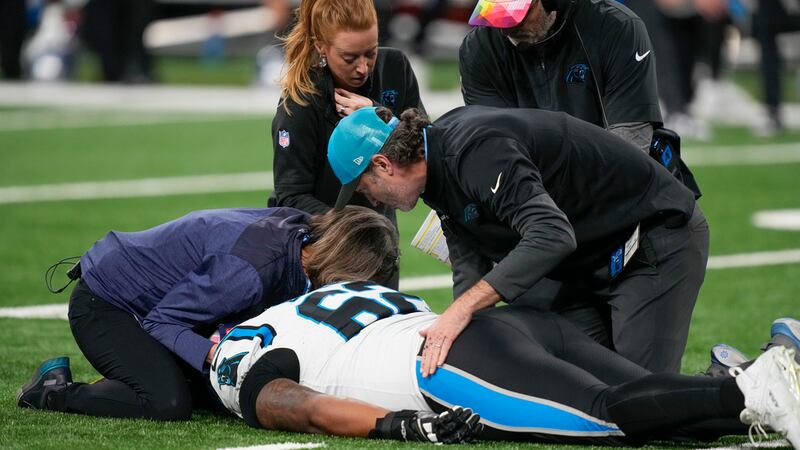 Carolina Panthers guard Chandler Zavala (62) is tended to after being injured in the first...