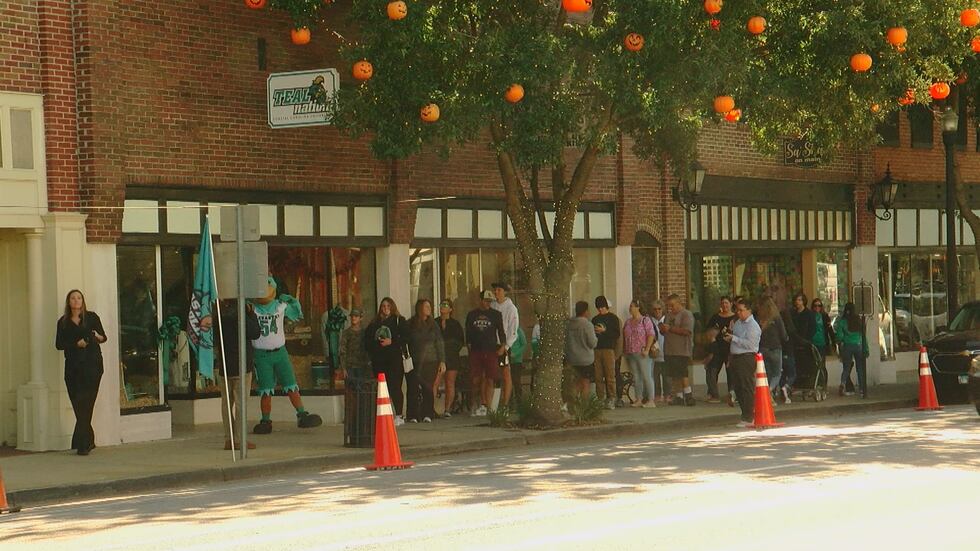 People waiting for the new Teal Nation store to open Monday morning.