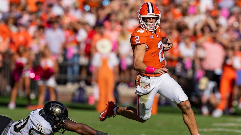 Clemson quarterback Cade Klubnik (2) runs with the ball while pursued by Wake Forest defensive...