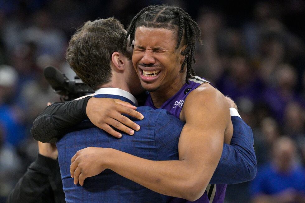 Furman guard Mike Bothwell, right, gets emotional after their win against Virginia during the...