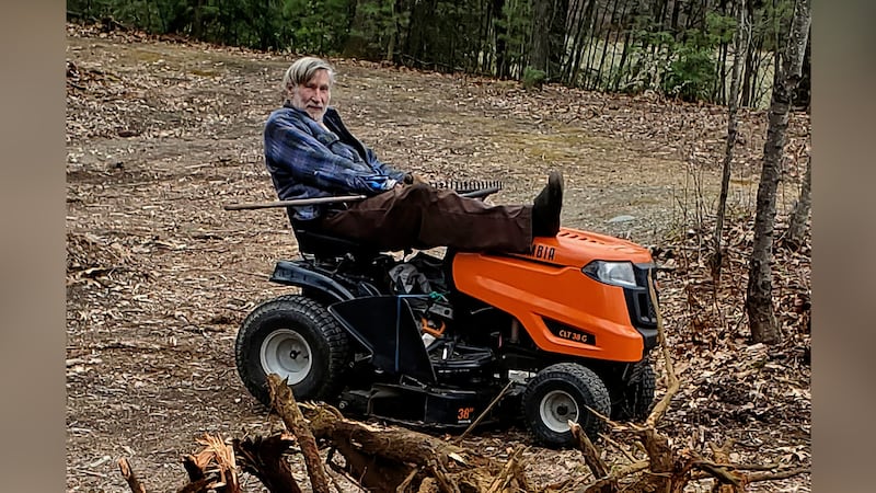 FILE -- Geoffrey Holt rests his leg on top of his riding mower in Hinsdale, N.H., on April 4,...