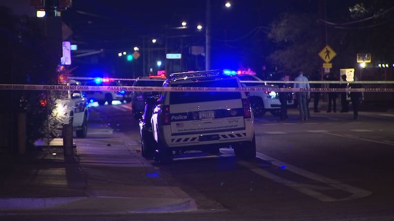 Crime scene taped off the area where a shooting took place in Phoenix. Police said nine people...