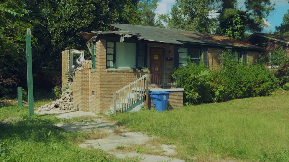 House with a caved in roof and damaged wall at 4913 Jones Street.